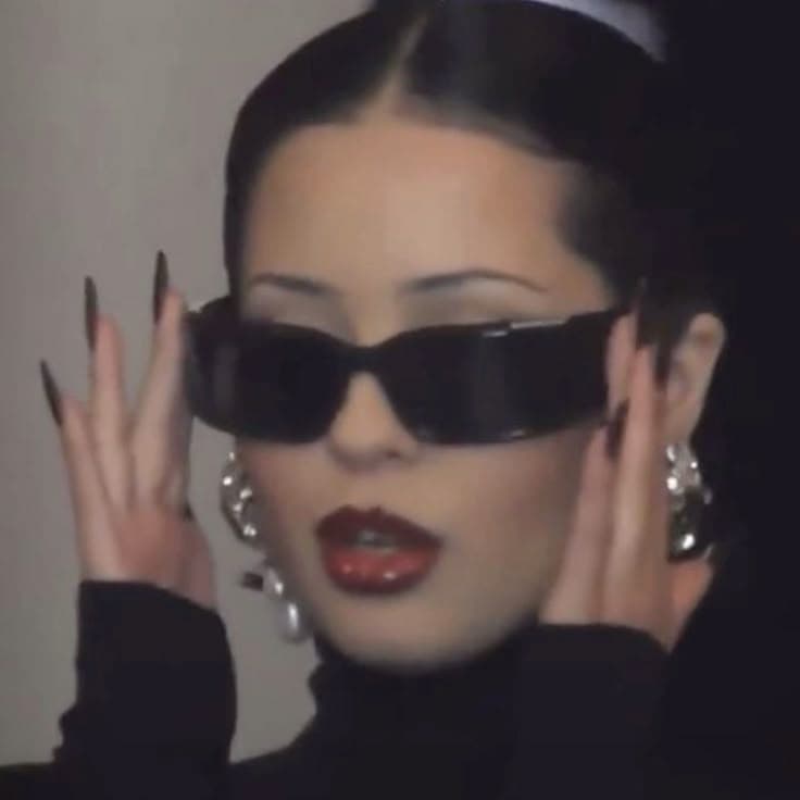 Woman in sunglasses adjusting her frames